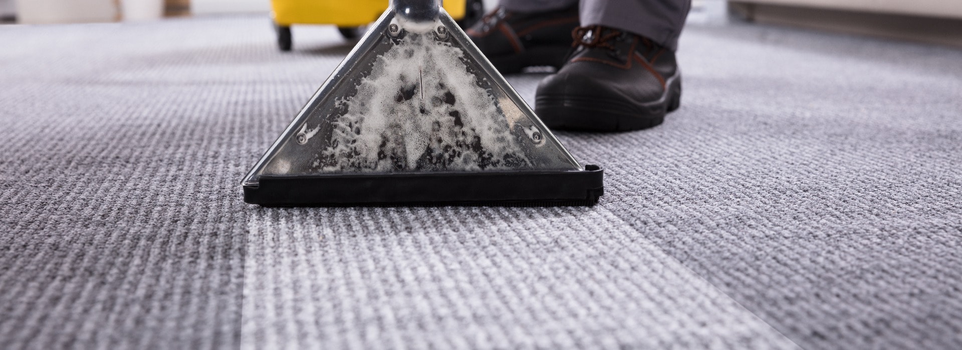 Person Cleaning Carpet With Vacuum Cleaner